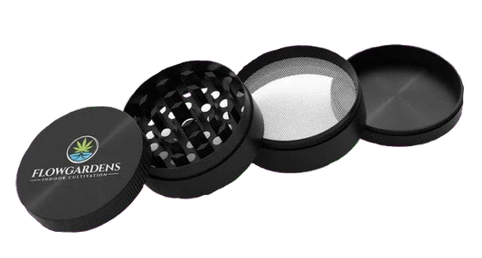 FlowGardens branded four-piece black herb grinder with mesh screen and logo lid