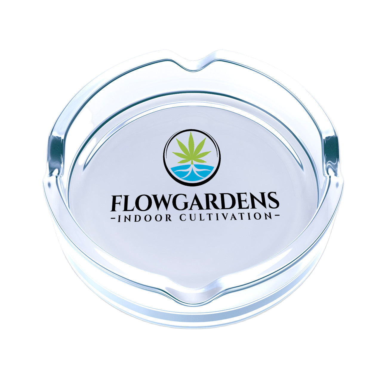 Clear glass ashtray with Flowgardens logo on a white background