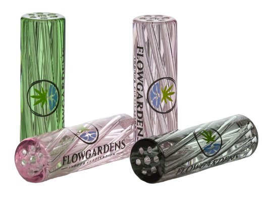 Glass smoking tips with 'Flowgardens' branding on a reflective surface.