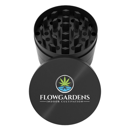 Black herb grinder with Flowgardens logo