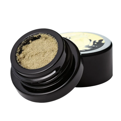 Dry sift kief cannabis concentrate in a black jar with open lid